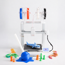 Load image into Gallery viewer, Toybox Luna Pro Mega 3D Printer Bundle: Luna 3D printer loaded with four Printer Food rolls, a printed shark on the bed and toys around it